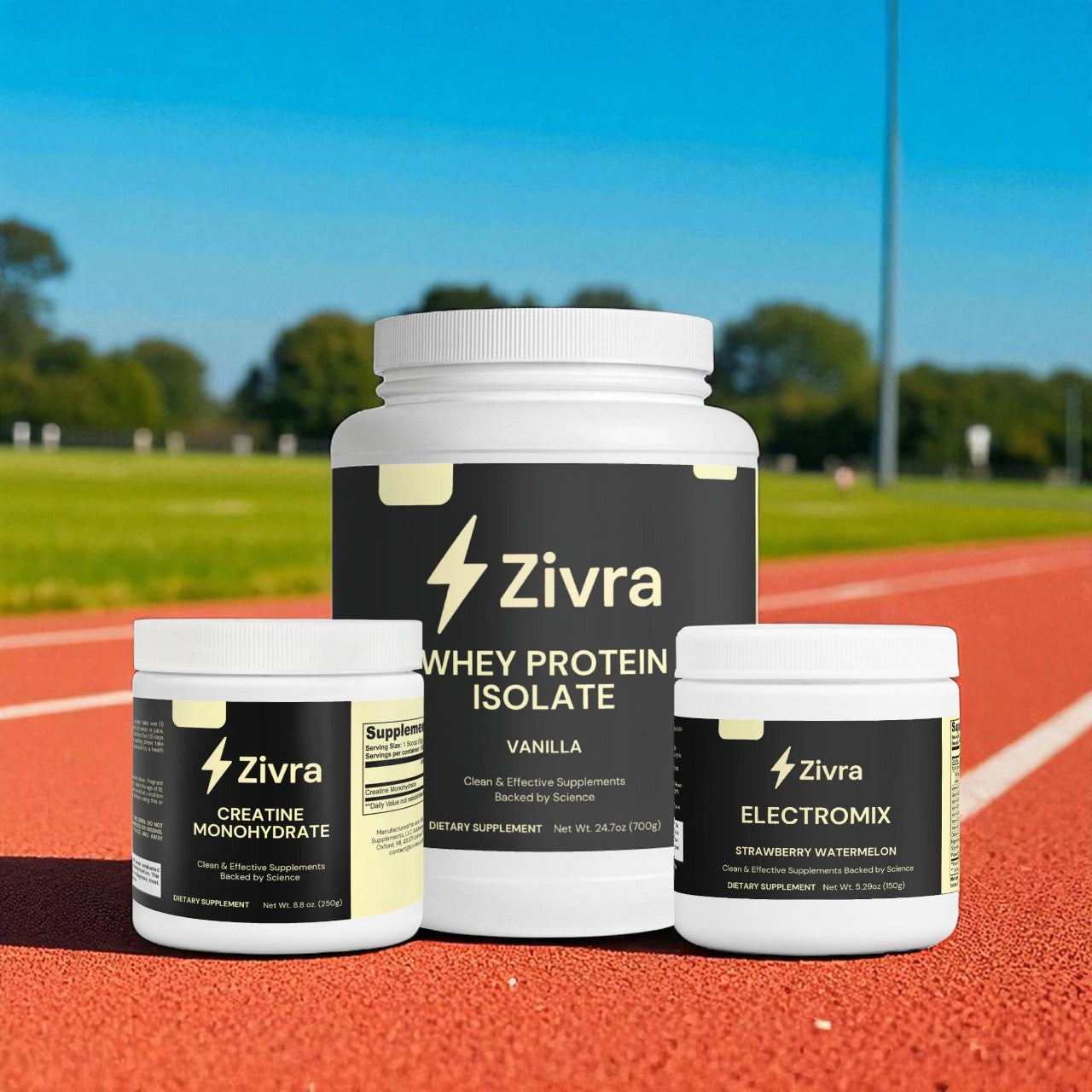 Zivra whey protein isolate, creatine monohydrate, and electromix containers on a running track.