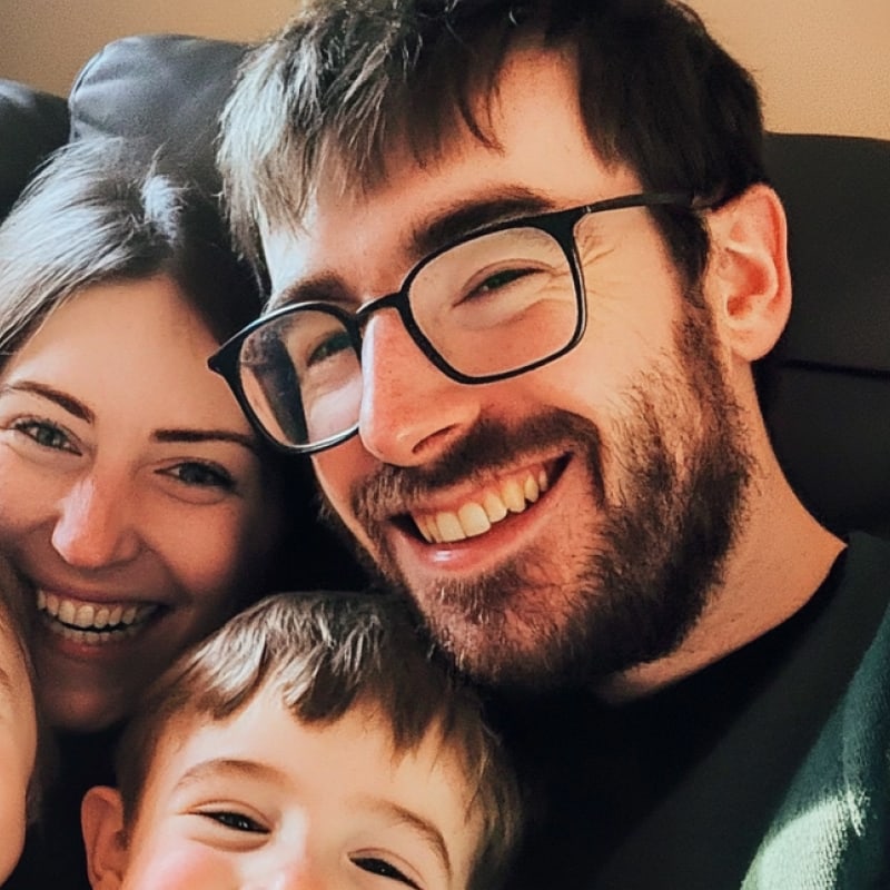 Family of three smiling close together